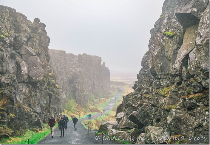People walking between the rift valley in Thingvellir National Park